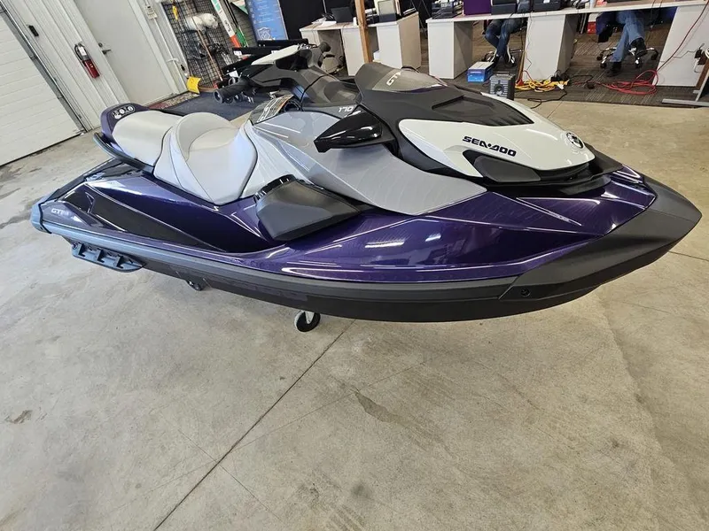 Slide: The Image of 2025 Sea-Doo GTI™ SE 170 jet ski in showroom, featuring Tech, Audio, iDF, iBR. - 3