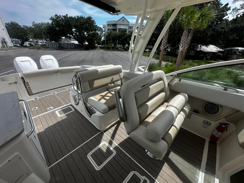 Slide: The Image of 2016 Boston Whaler 320 Vantage boat interior with seating and deck view. - 11