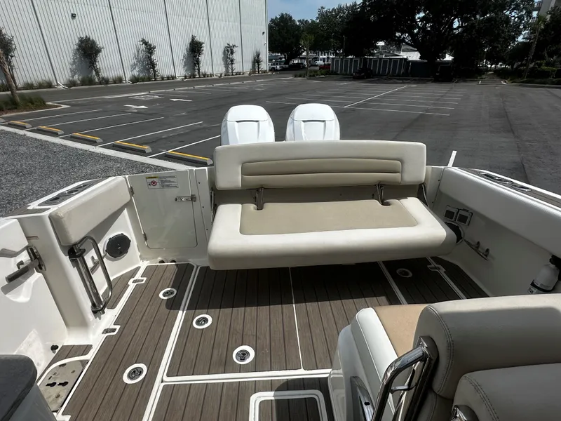 Slide: The Image of 2016 Boston Whaler 320 Vantage boat interior with seating and deck view. - 16