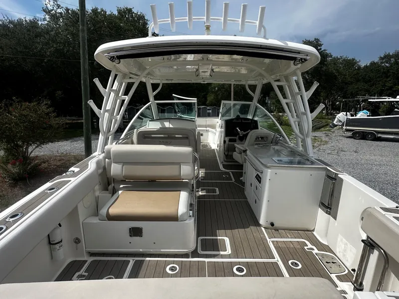 Slide: The Image of 2016 Boston Whaler 320 Vantage boat interior with seating and helm station. - 17