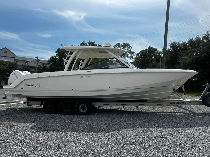 The Image of 2016 Boston Whaler 320 Vantage boat on trailer, parked outdoors. - 2