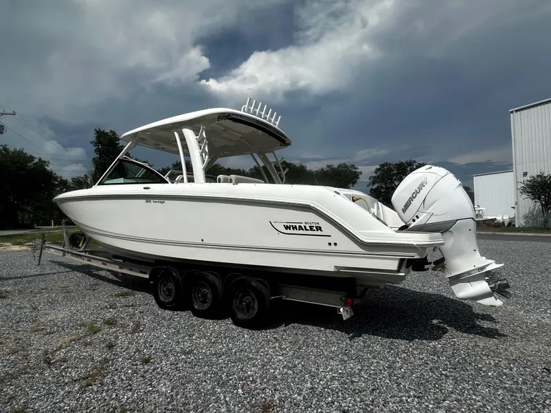Slide: The Image of 2016 Boston Whaler 320 Vantage boat on trailer, parked outdoors. - 3