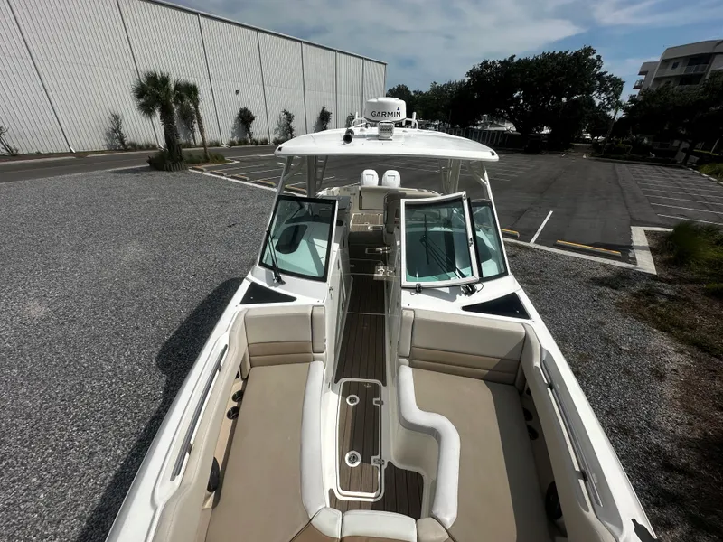 Slide: The Image of 2016 Boston Whaler 320 Vantage boat, docked, with spacious seating and modern design. - 6