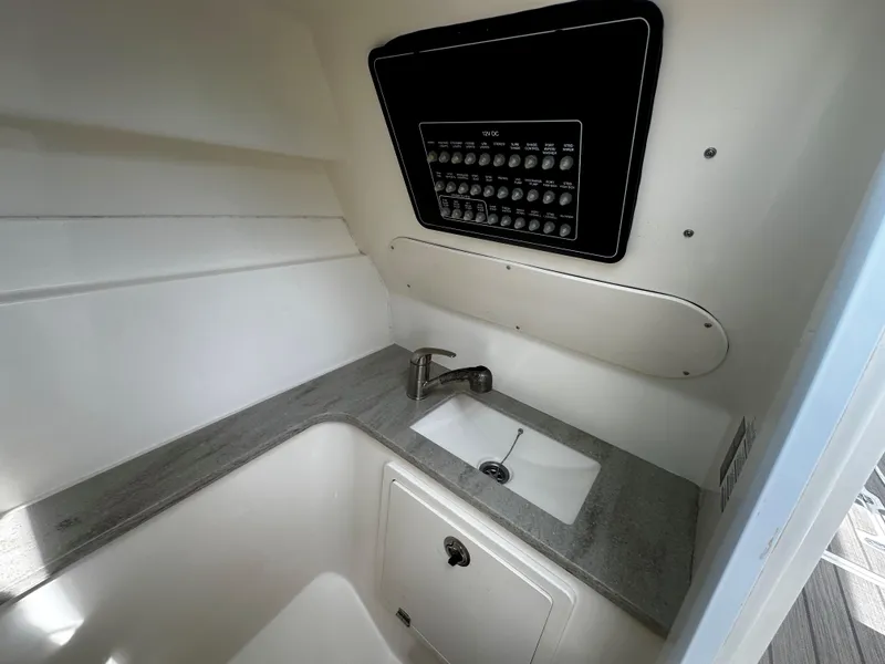 Slide: The Image of 2016 Boston Whaler 320 Vantage interior sink and control panel. - 8