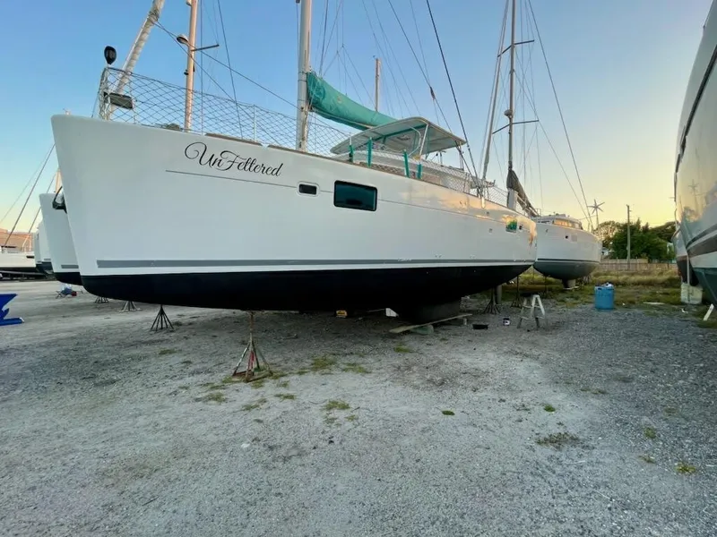 Slide: The Image of 2015 Lagoon 450 F catamaran on land, sunset background. - 4