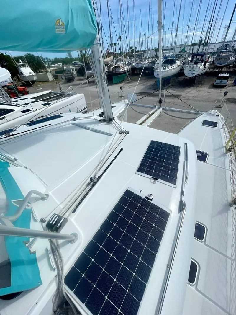 Slide: The Image of 2015 Lagoon 450 F catamaran with solar panels in a marina. - 43