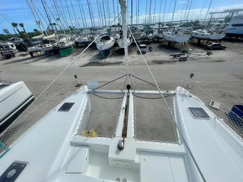 Slide: The Image of 2015 Lagoon 450 F catamaran on dry dock, surrounded by other boats. - 46