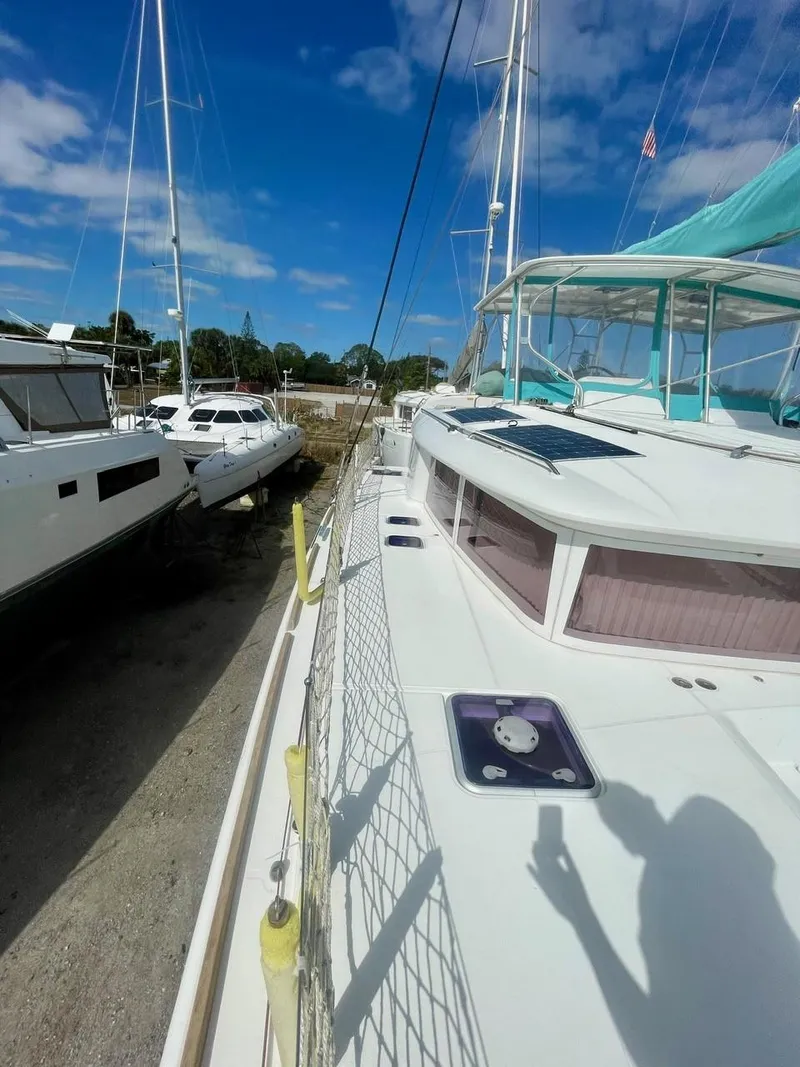 Slide: The Image of 2015 Lagoon 450 F catamaran docked under clear blue sky. - 47