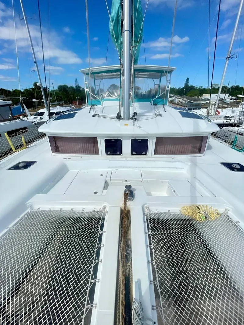 Slide: The Image of 2015 Lagoon 450 F catamaran deck with netting and clear blue sky. - 49