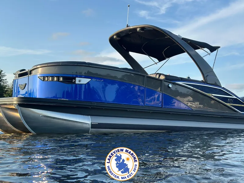 The Image of 2024 Bennington RX 23 RXSBA pontoon boat on water, featuring sleek blue and black design. - 0