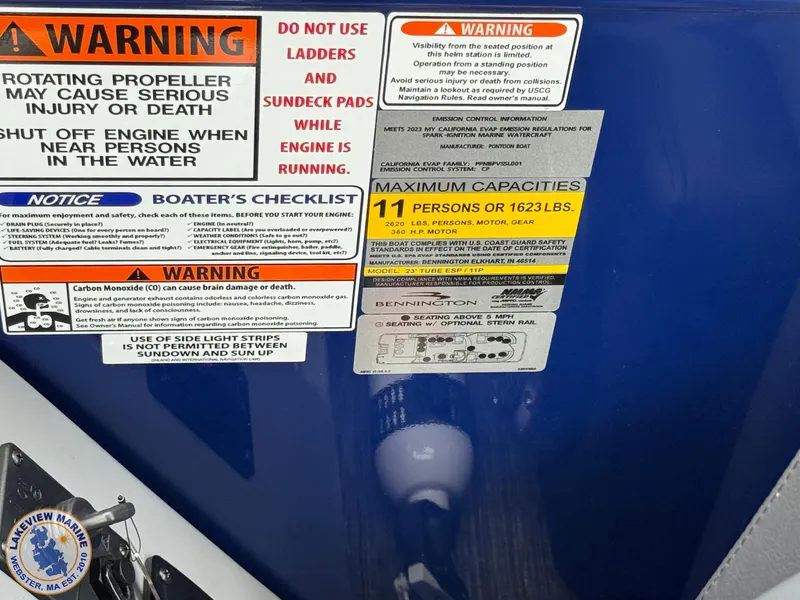 Slide: The Image of 2024 Bennington RX 23 RXSBA warning labels and capacity information on blue surface. - 13