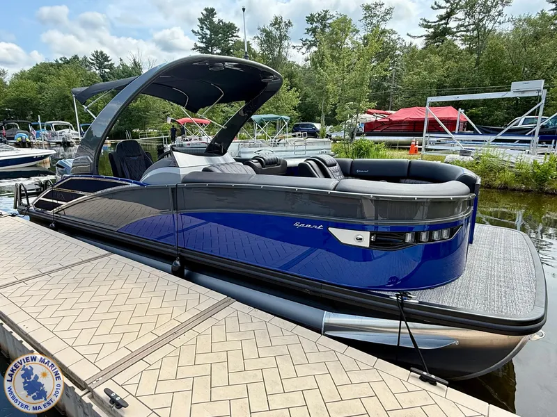 Slide: The Image of 2024 Bennington RX 23 RXSBA pontoon boat docked at a marina. - 14