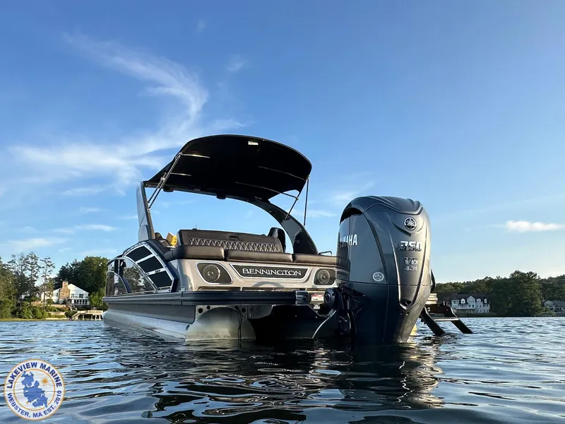 Slide: The Image of 2024 Bennington RX 23 RXSBA pontoon boat on calm water with Yamaha engine. - 16