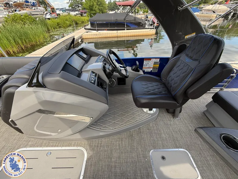 Slide: The Image of 2024 Bennington RX 23 RXSBA boat helm with luxurious seating and modern dashboard controls. - 7