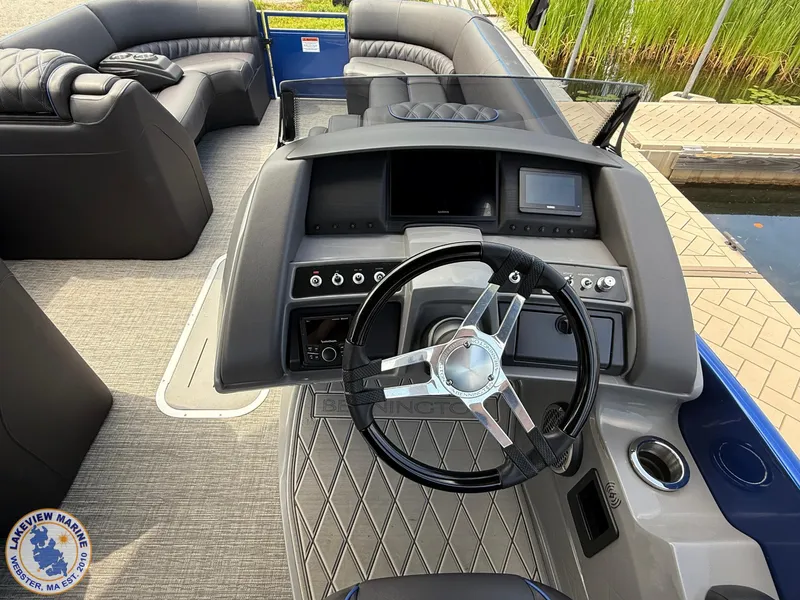 Slide: The Image of 2024 Bennington RX 23 RXSBA boat interior with steering wheel and dashboard controls. - 8
