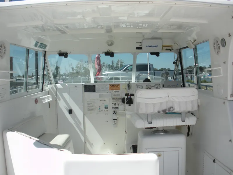 Slide: The Image of Interior of 1999 Baha Cruisers 290 King Cat Ht boat, featuring helm and seating area. - 10