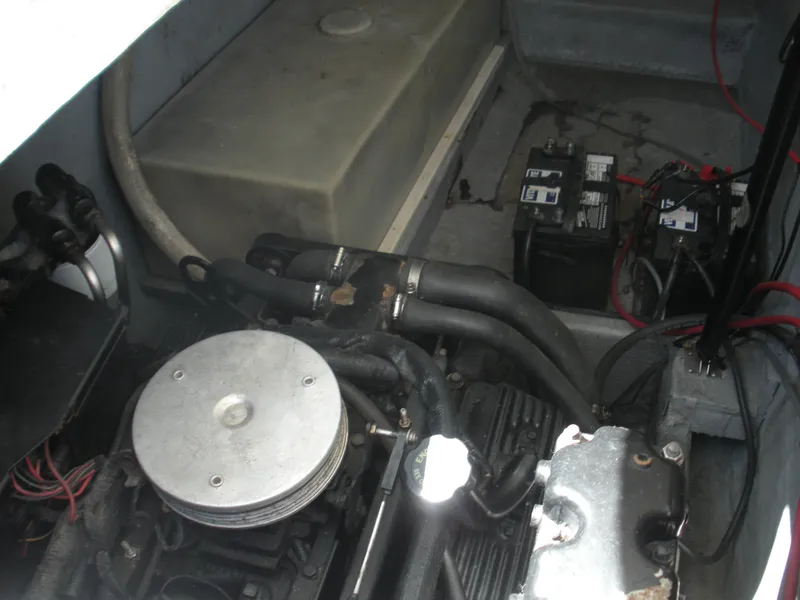 Slide: The Image of Engine compartment of 1999 Baha Cruisers 290 King Cat Ht with visible battery and components. - 13