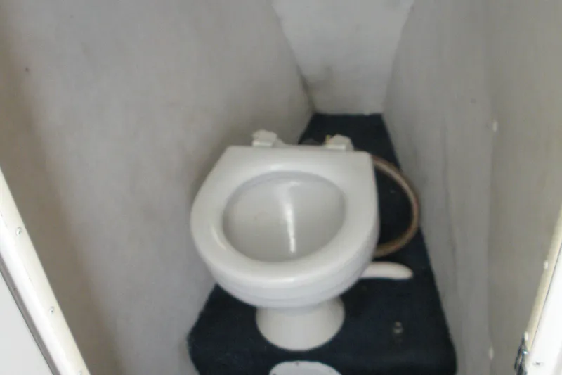 Slide: The Image of Toilet in 1999 Baha Cruisers 290 King Cat Ht boat interior. - 5