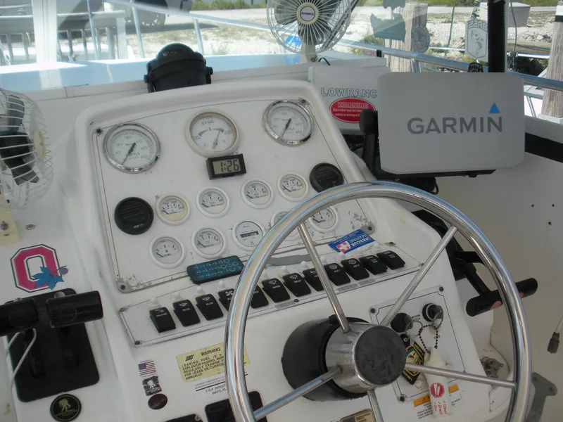 Slide: The Image of 1999 Baha Cruisers 290 King Cat Ht helm with Garmin navigation system and gauges. - 7