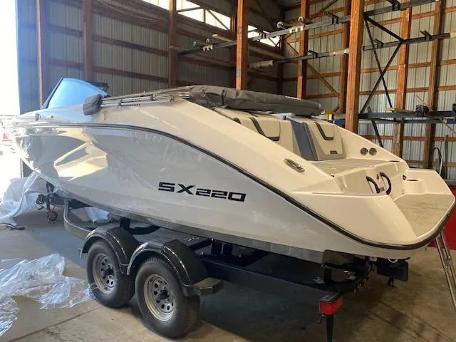 Slide: The Image of 2025 Yamaha Boats SX220 in a storage facility on a trailer. - 1