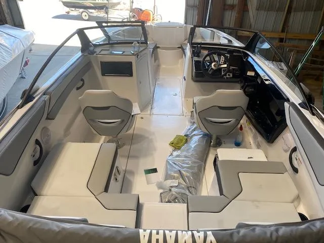 Slide: The Image of 2025 Yamaha Boats SX220 interior with seating and steering wheel in a garage setting. - 3