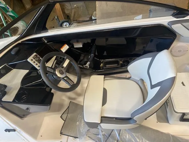 Slide: The Image of 2025 Yamaha Boats SX220 cockpit with steering wheel and modern seating. - 4