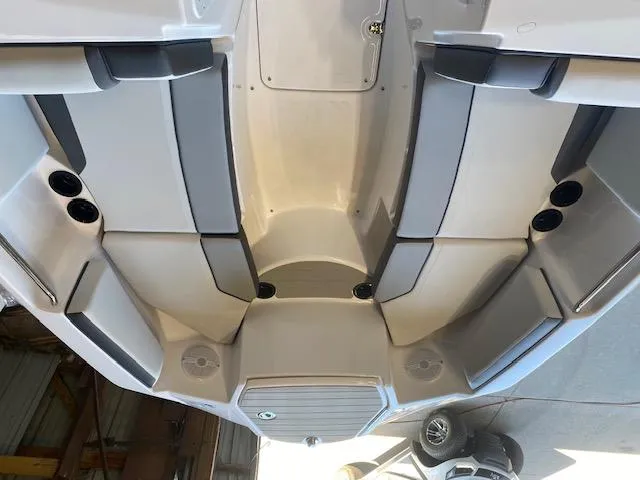 Slide: The Image of 2025 Yamaha Boats SX220 interior with gray seating and cup holders. - 6