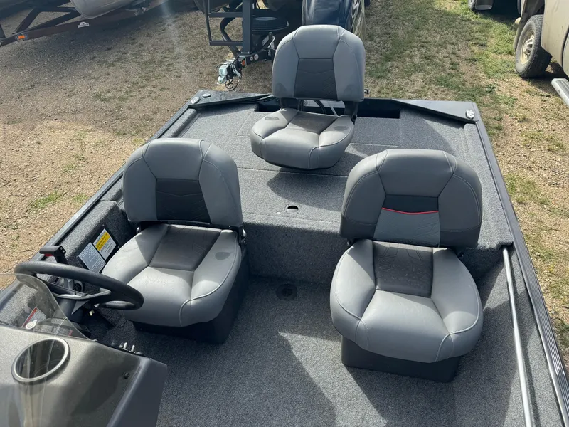 Slide: The Image of 2024 Tracker Bass Tracker Classic XL boat interior with three gray seats. - 11
