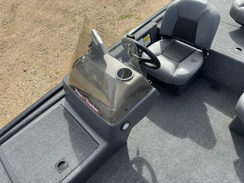 Slide: The Image of 2024 Tracker Bass Tracker Classic XL boat interior with steering console and seating. - 12