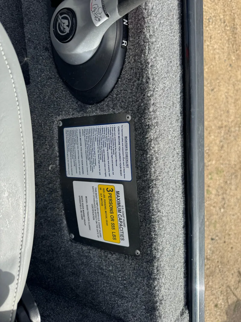 Slide: The Image of 2024 Tracker Bass Tracker Classic XL interior with safety and capacity labels. - 16