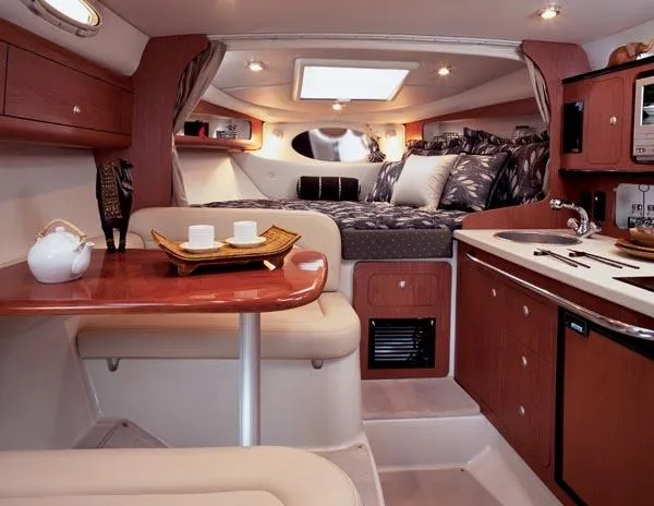 Slide: The Image of Interior of 2005 Chaparral Signature 270 boat with cozy seating, kitchenette, and bed. - 12