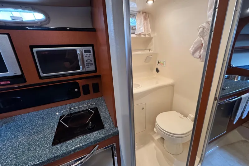 Slide: The Image of 2005 Chaparral Signature 270 interior with kitchenette and compact bathroom. - 17