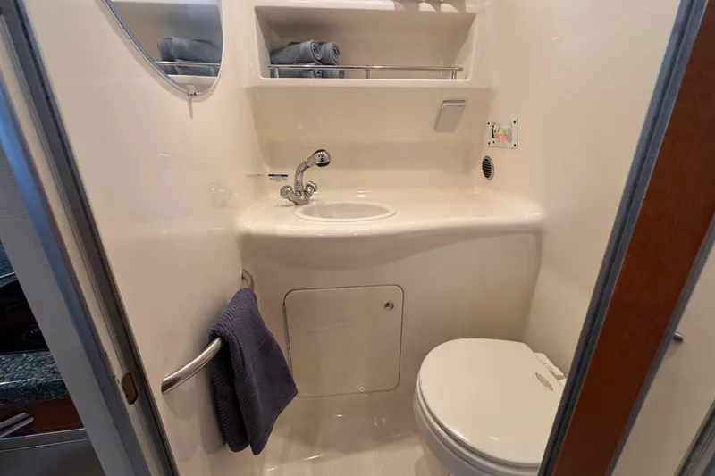 Slide: The Image of 2005 Chaparral Signature 270 bathroom with sink, toilet, and towel rack. - 18