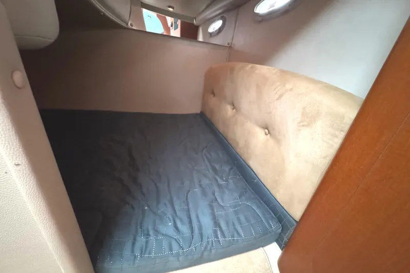 Slide: The Image of Interior cabin of 2005 Chaparral Signature 270 boat with cushioned bed. - 19