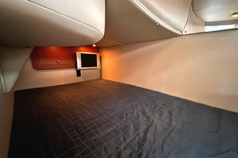 Slide: The Image of 2005 Chaparral Signature 270 cabin interior with bed and mounted TV. - 20