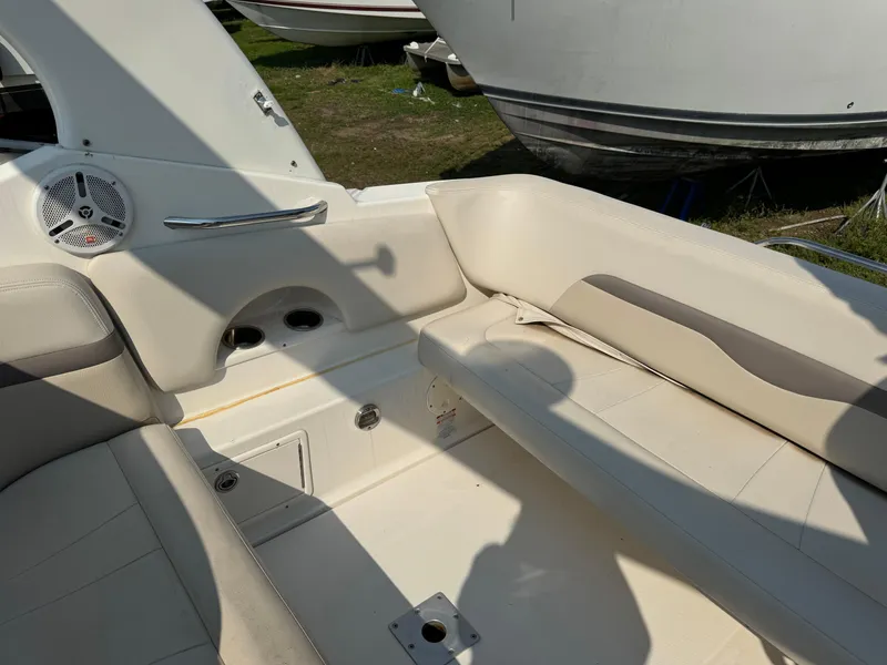 Slide: The Image of 2005 Chaparral Signature 270 boat interior with white seating and dashboard controls. - 4