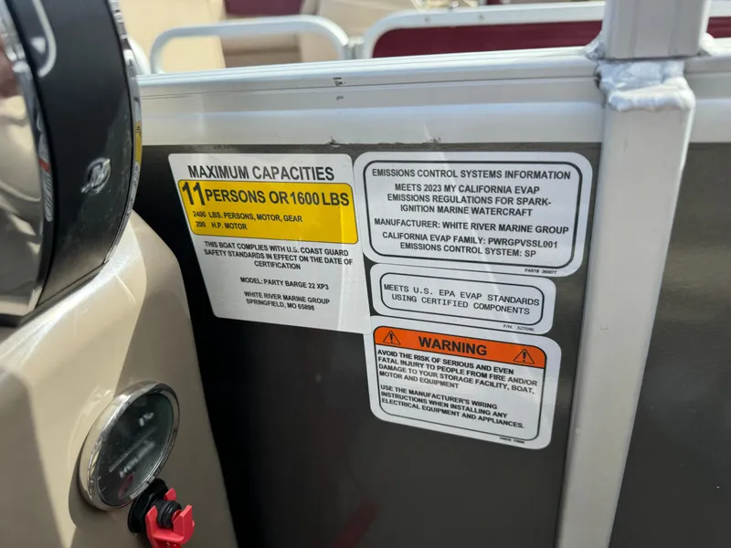 Slide: The Image of Capacity and emissions labels on 2023 Sun Tracker Party Barge 22 XP3 boat. - 18