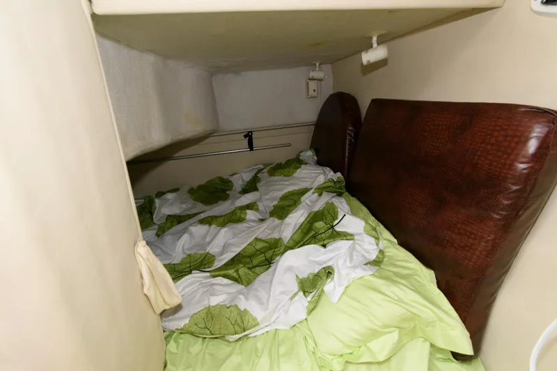 Slide: The Image of Cozy sleeping area in a 2005 Monterey 250 Cruiser boat cabin. - 10