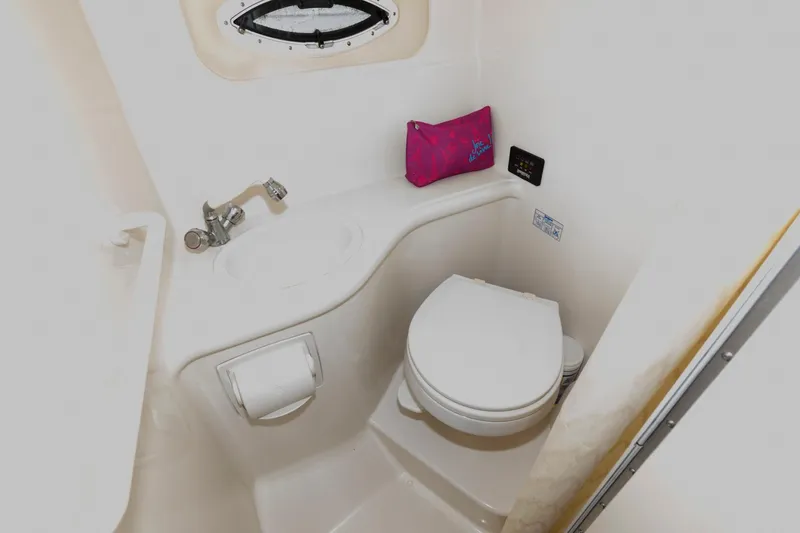 Slide: The Image of 2005 Monterey 250 Cruiser bathroom with toilet, sink, and small window. - 11