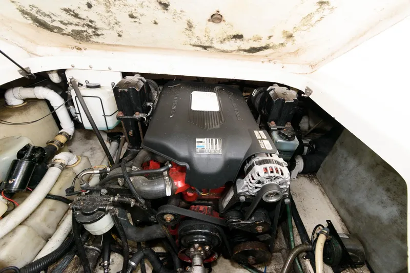 Slide: The Image of Engine compartment of a 2005 Monterey 250 Cruiser boat, showing detailed mechanical components. - 12