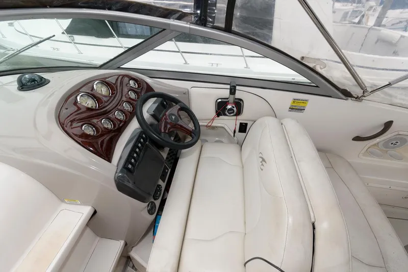 Slide: The Image of 2005 Monterey 250 Cruiser boat interior with steering wheel and dashboard controls. - 5
