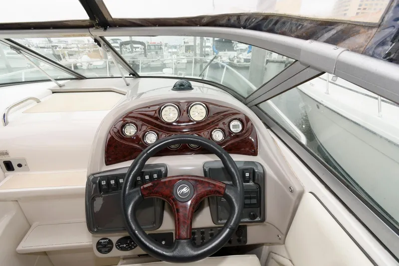 Slide: The Image of 2005 Monterey 250 Cruiser dashboard with wood accents and steering wheel. - 6