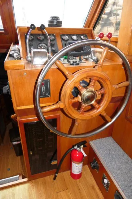 Slide: The Image of 1986 Nova 36 Sundeck boat helm with wooden steering wheel and control panel. - 10