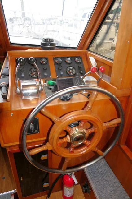 Slide: The Image of 1986 Nova 36 SUNDECK helm with wooden wheel and control panel. - 11