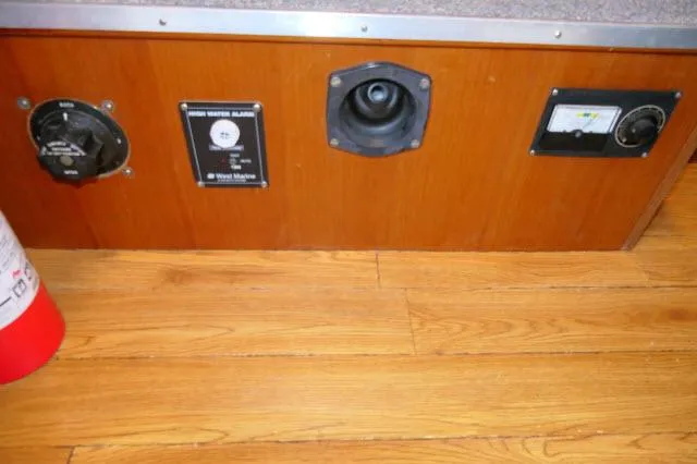 Slide: The Image of Control panel on 1986 Nova 36 Sundeck boat with wood finish and safety equipment. - 14