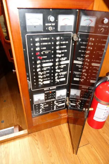 Slide: The Image of Electrical panel on 1986 Nova 36 Sundeck boat with fire extinguisher nearby. - 15