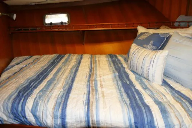 Slide: The Image of Cozy cabin bed with blue-striped bedding in 1986 Nova 36 Sundeck yacht. - 28