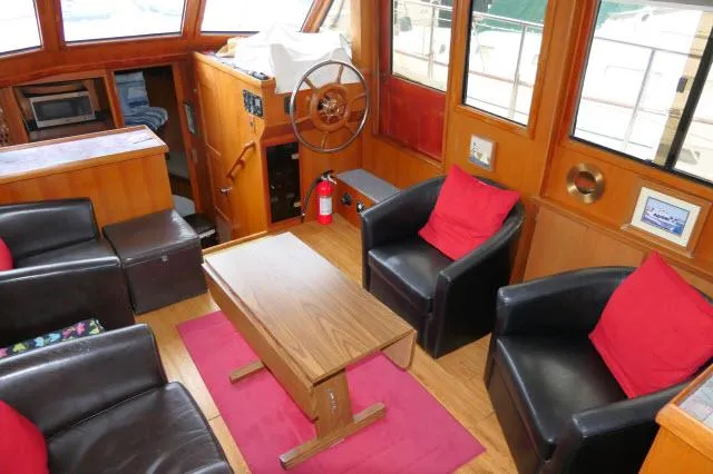 Slide: The Image of Interior of 1986 Nova 36 Sundeck yacht with seating, table, and helm. - 3