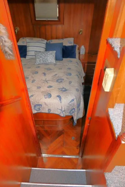 Slide: The Image of Cozy cabin interior of 1986 Nova 36 Sundeck with nautical-themed bedding. - 33