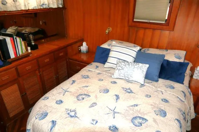 Slide: The Image of Cozy bedroom in 1986 Nova 36 Sundeck with nautical-themed bedding and wooden cabinetry. - 34